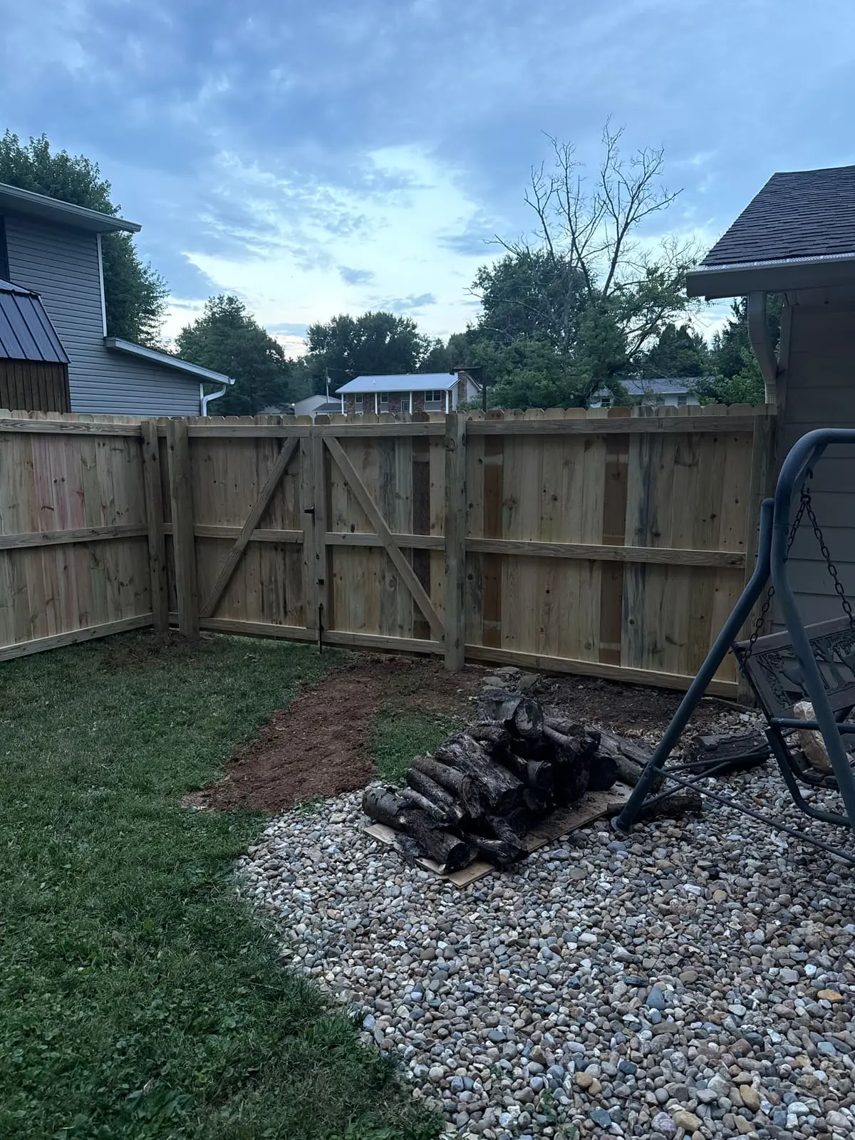 After: new wood privacy fence with a braced gate enclosing the backyard in Bloomington, IN