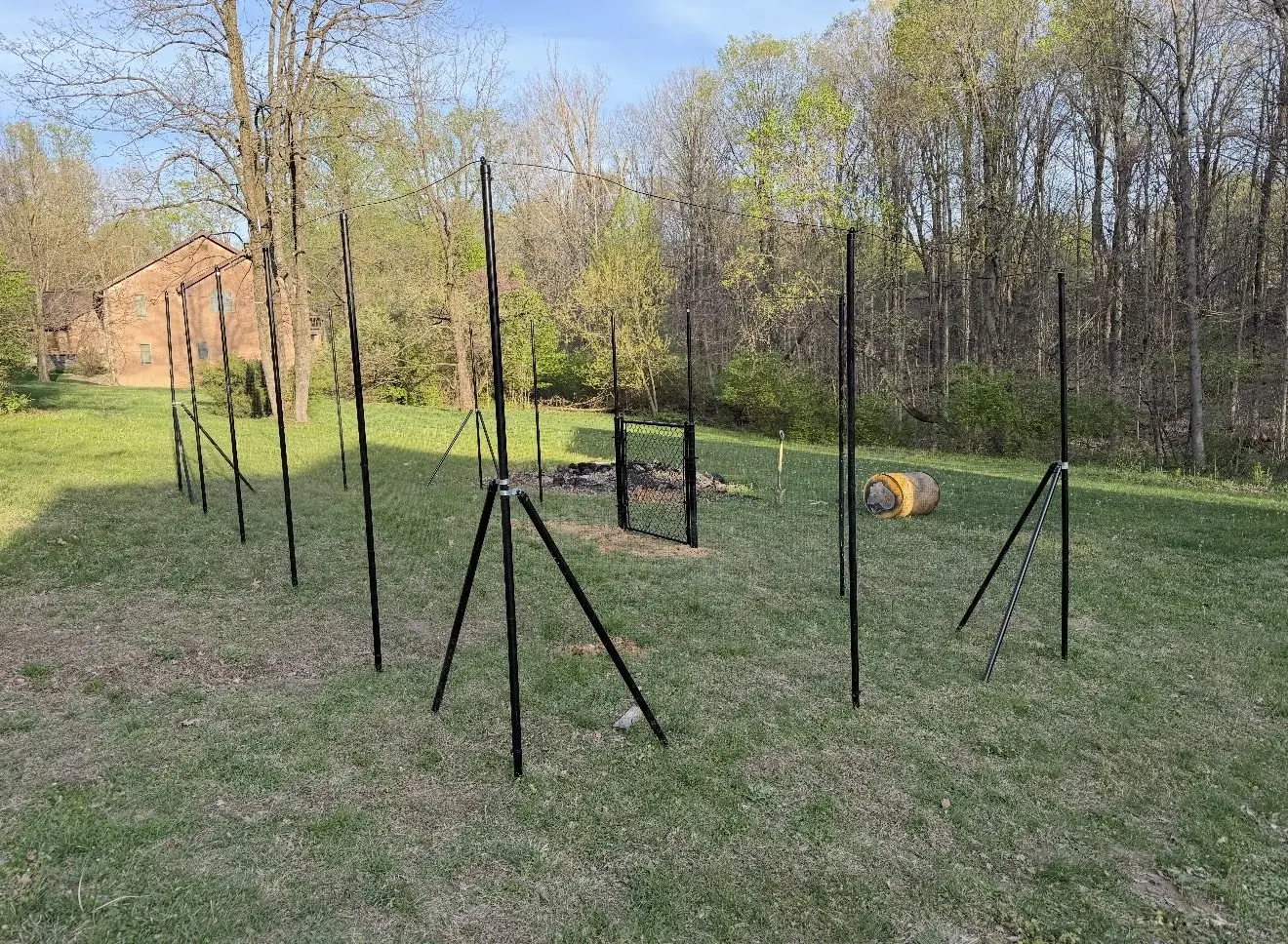 Black metal garden fence installation in progress in Bloomington, IN