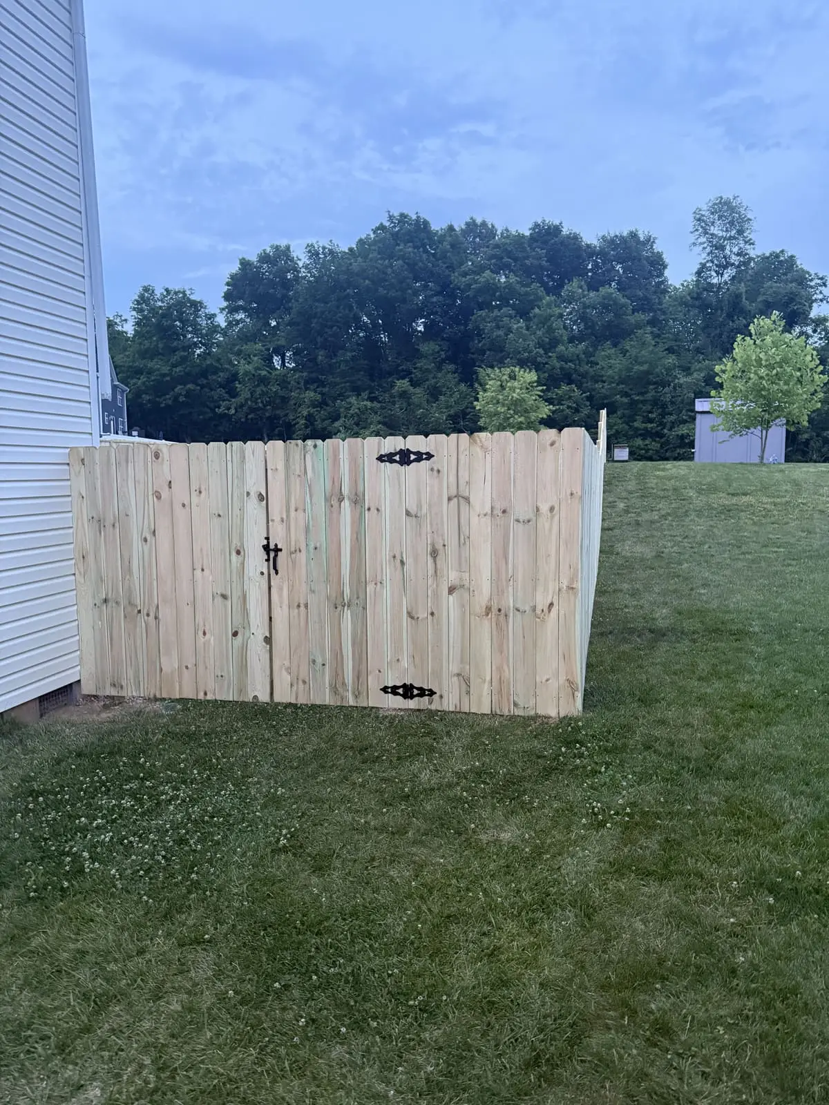 Wood privacy fence corner with gate in Bloomington, IN