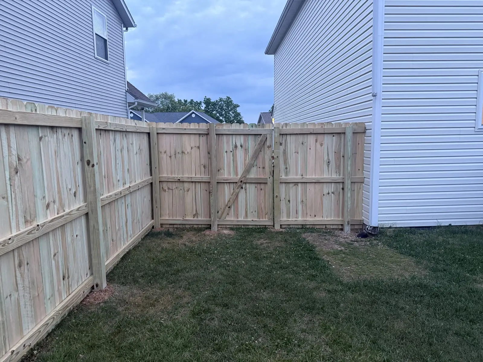 Wood privacy fence and gate installed between two homes in Bloomington, IN