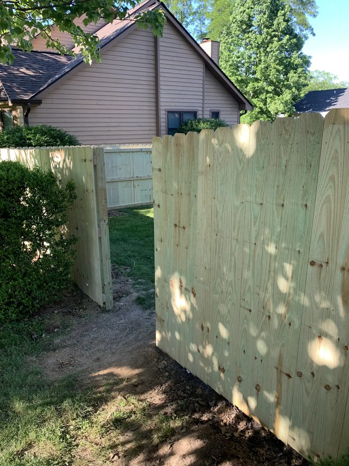 Wood privacy fence with a gate opening in Bloomington, IN