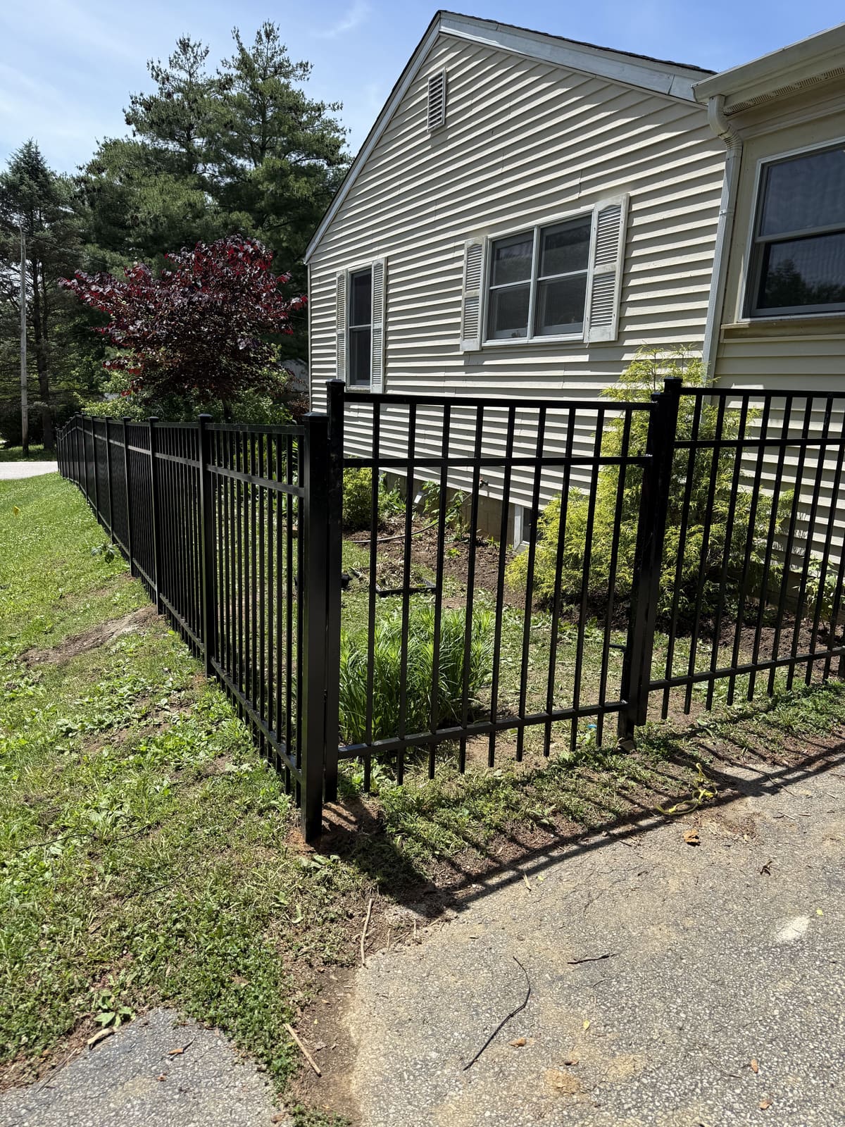 Black aluminum fence corner installation at a home in Bloomington, IN