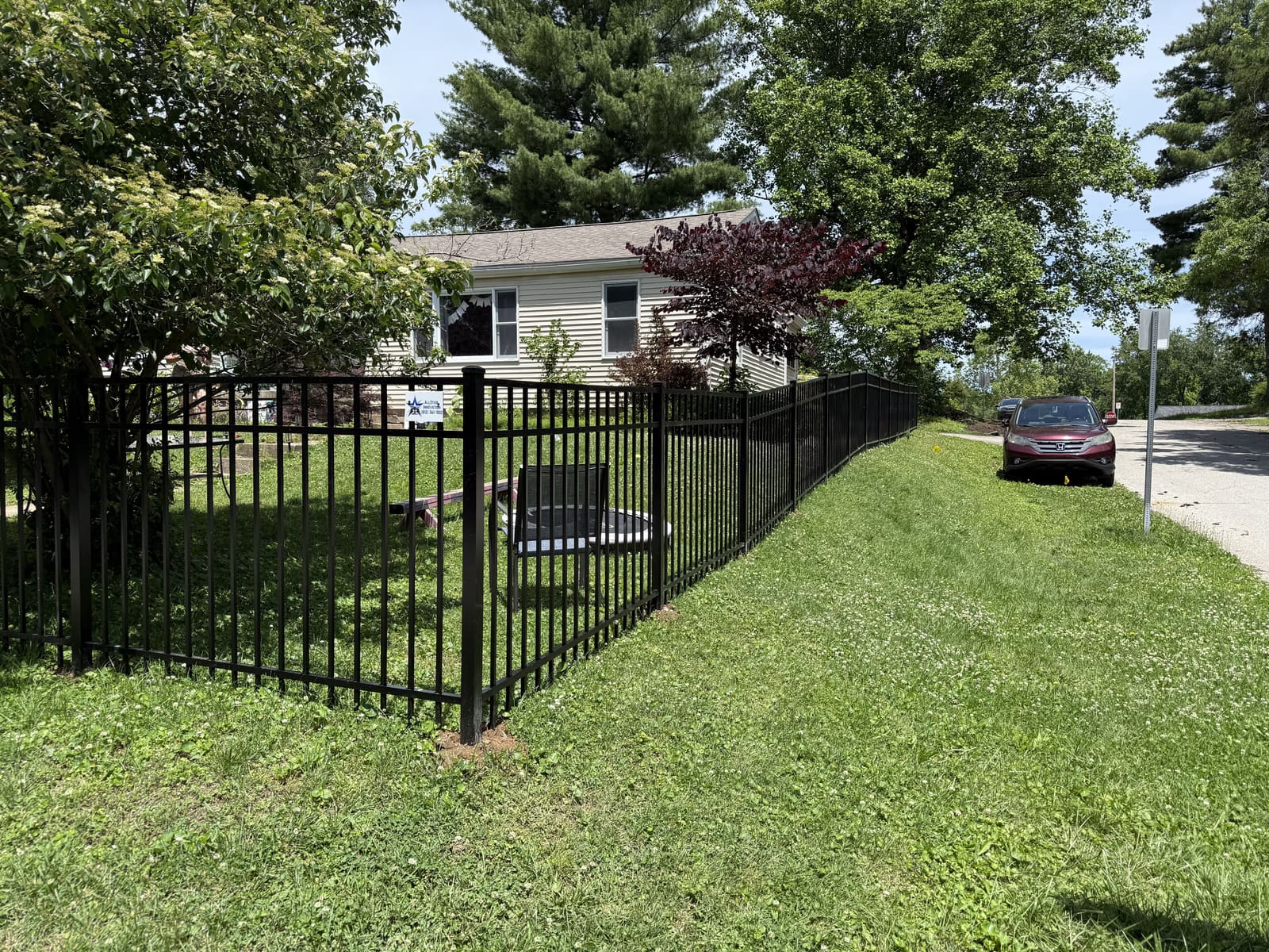 Black aluminum fence installed around a residential yard in Bloomington, IN