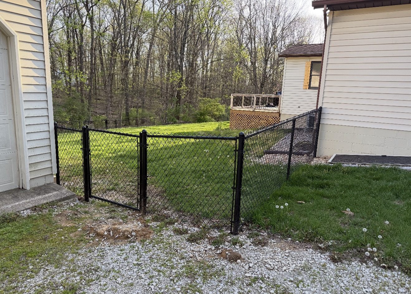 Black chain link fence installed in a residential yard in Bloomington, IN