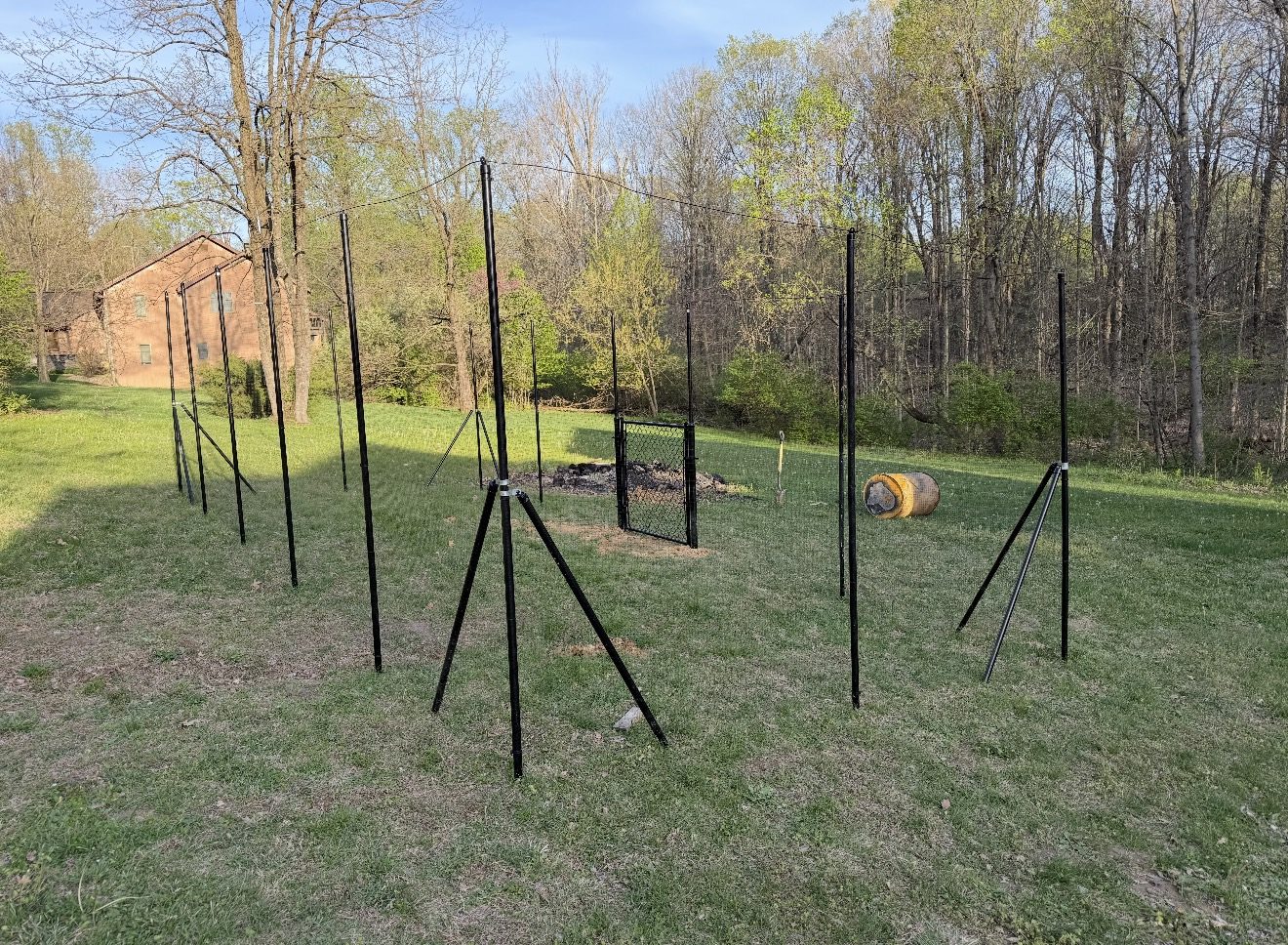 Black metal garden fence installation in progress in Bloomington, IN
