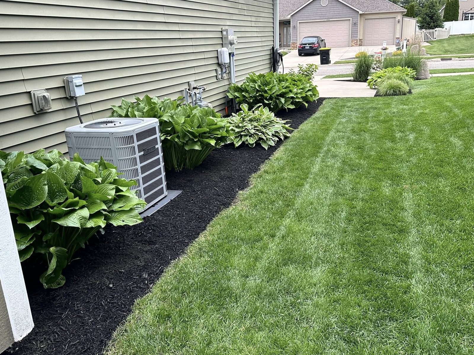 Mulch bed landscaping installation along a home in Bloomington, IN