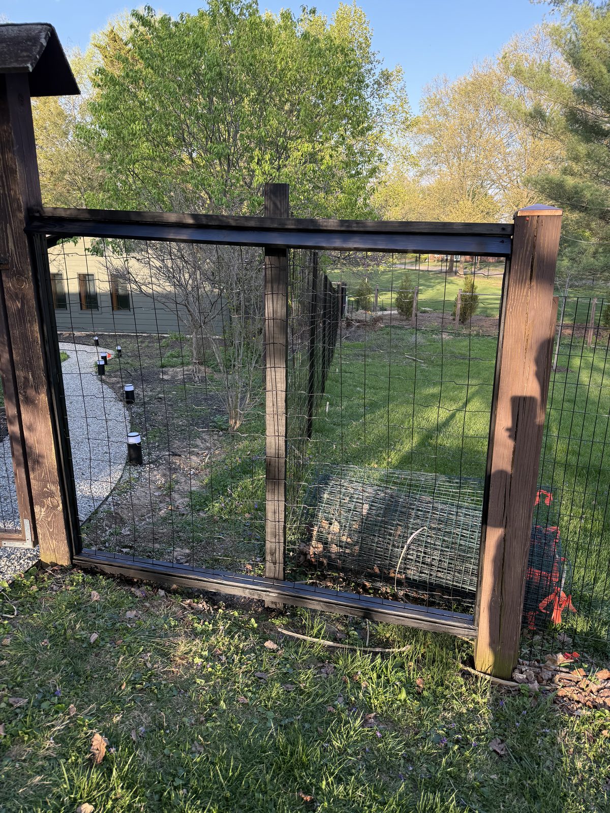 Black welded wire fence gate with a wood frame in Bloomington, IN