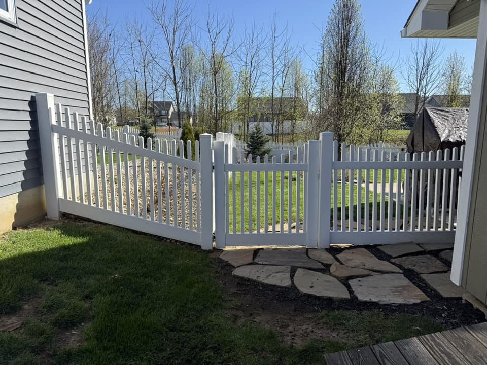 White vinyl picket fence and gate with flagstone walkway in Bloomington, IN