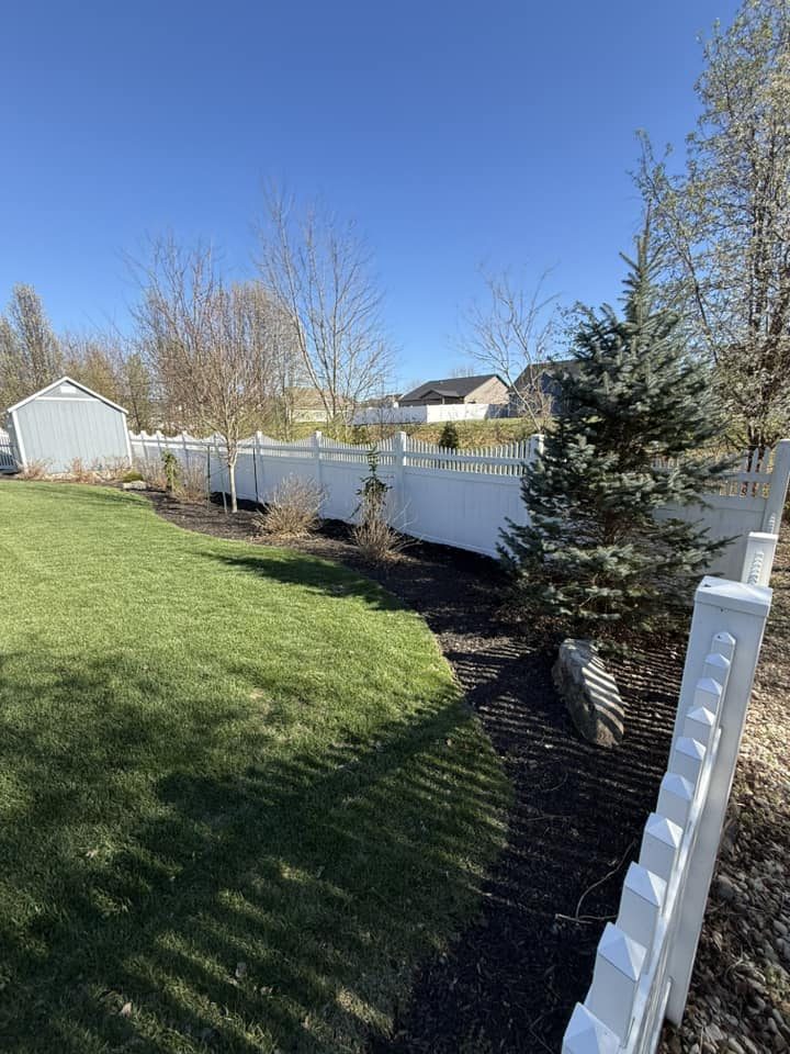 White vinyl privacy fence with landscaped backyard in Bloomington, IN