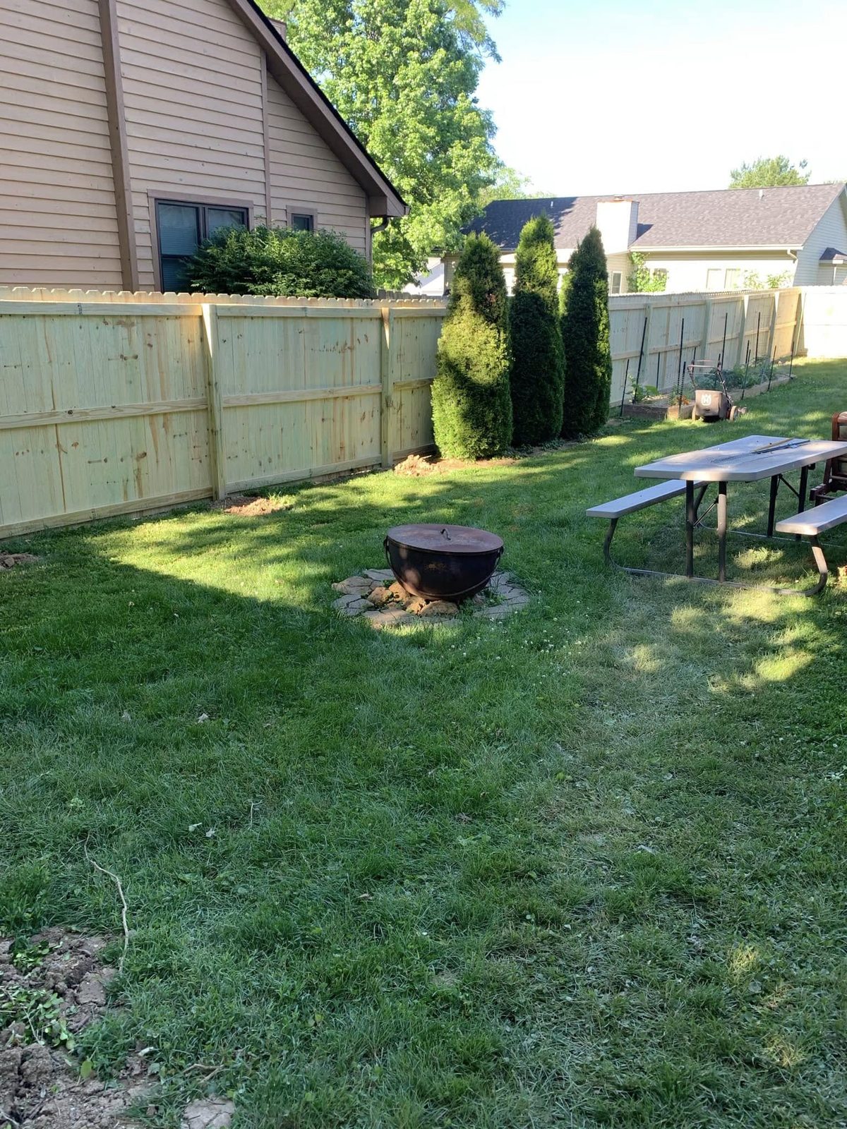 Wood privacy fence installed along a backyard in Bloomington, IN