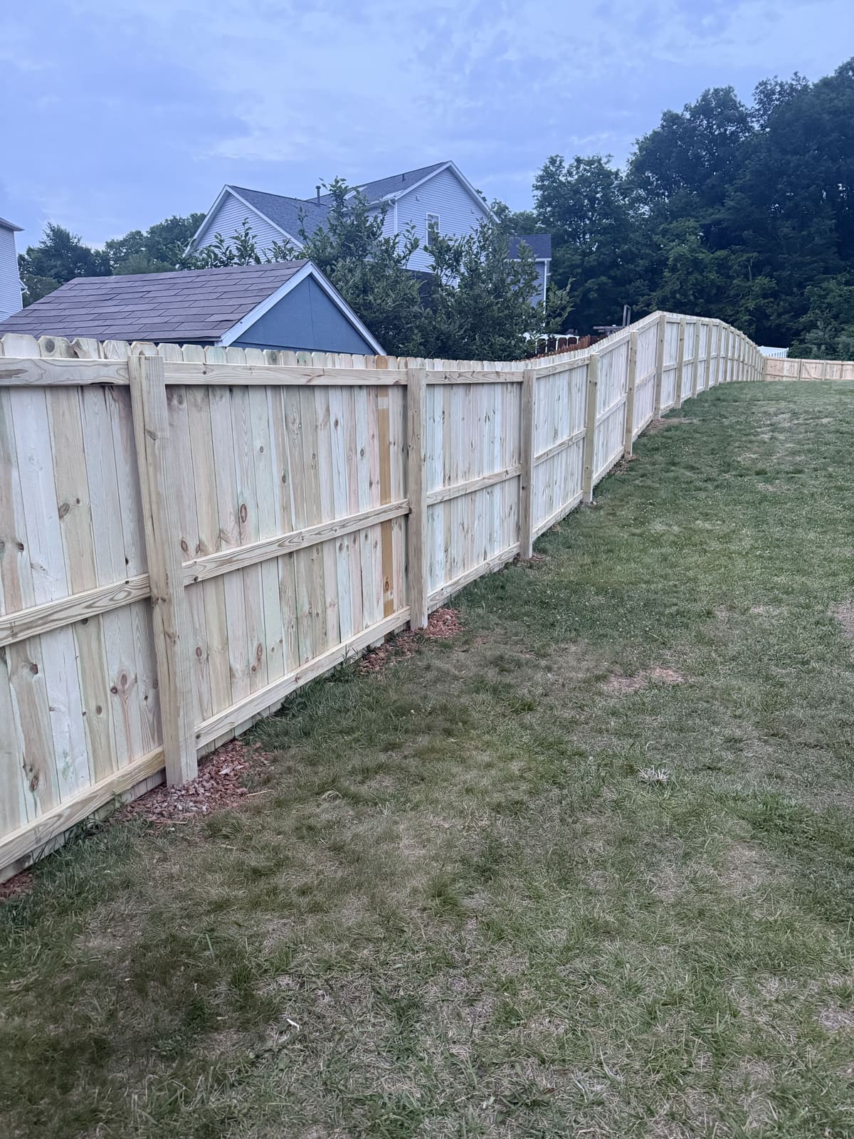 Wood privacy fence following a curved property line in Bloomington, IN