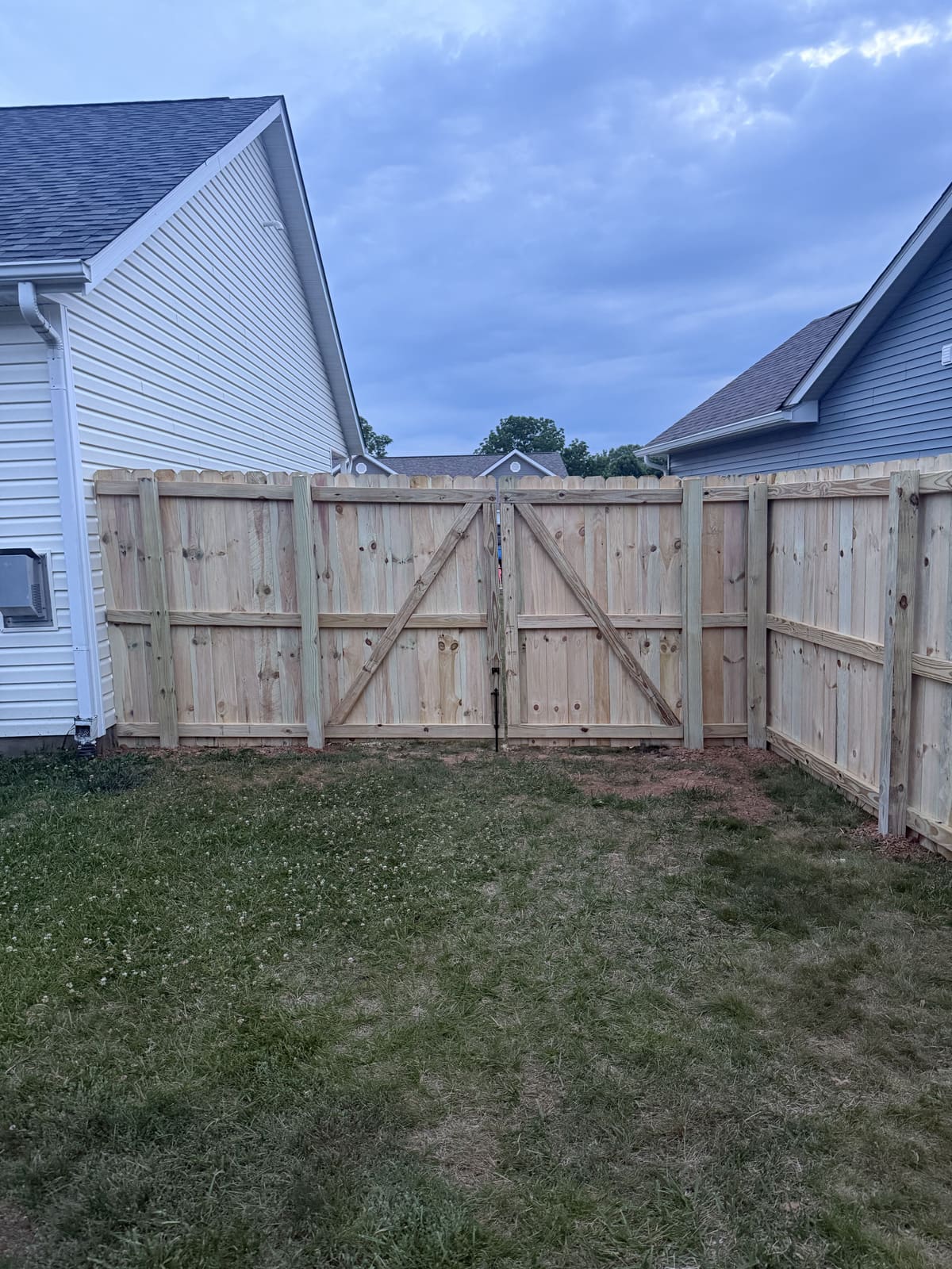 Wood privacy fence with double gate between houses in Bloomington, IN