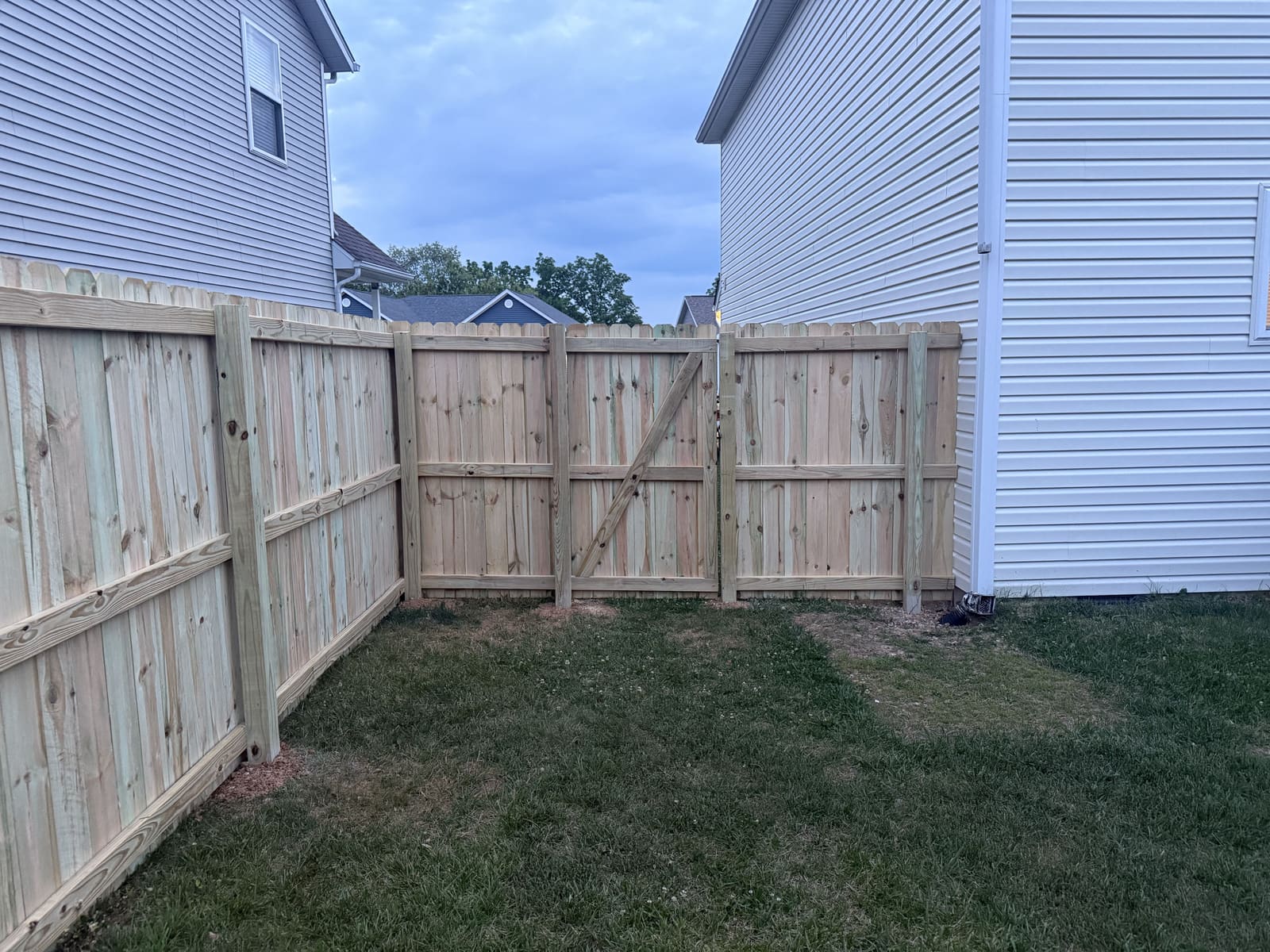 Wood privacy fence and gate installed between two homes in Bloomington, IN