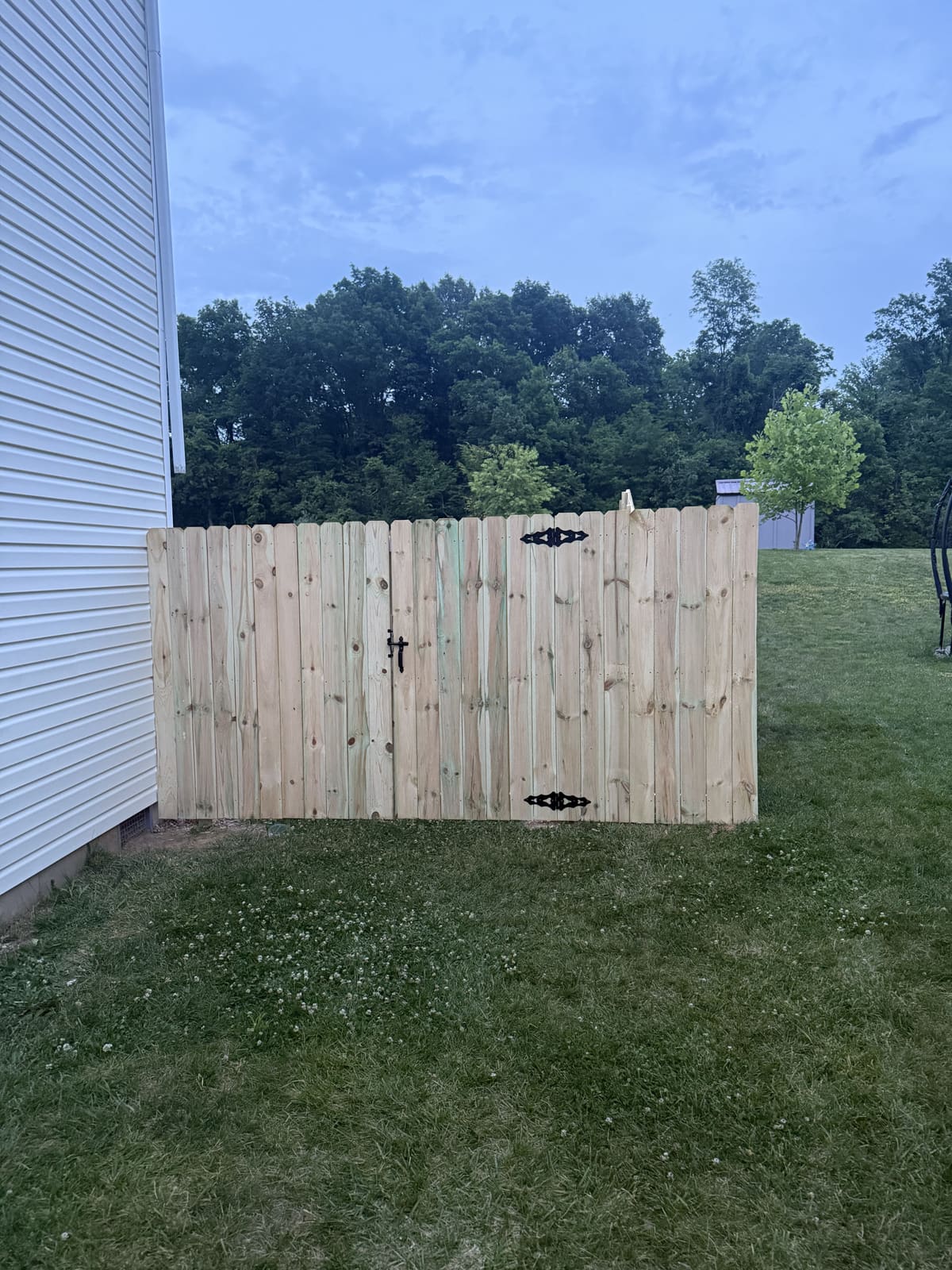 Wood privacy fence gate with black hardware in Bloomington, IN