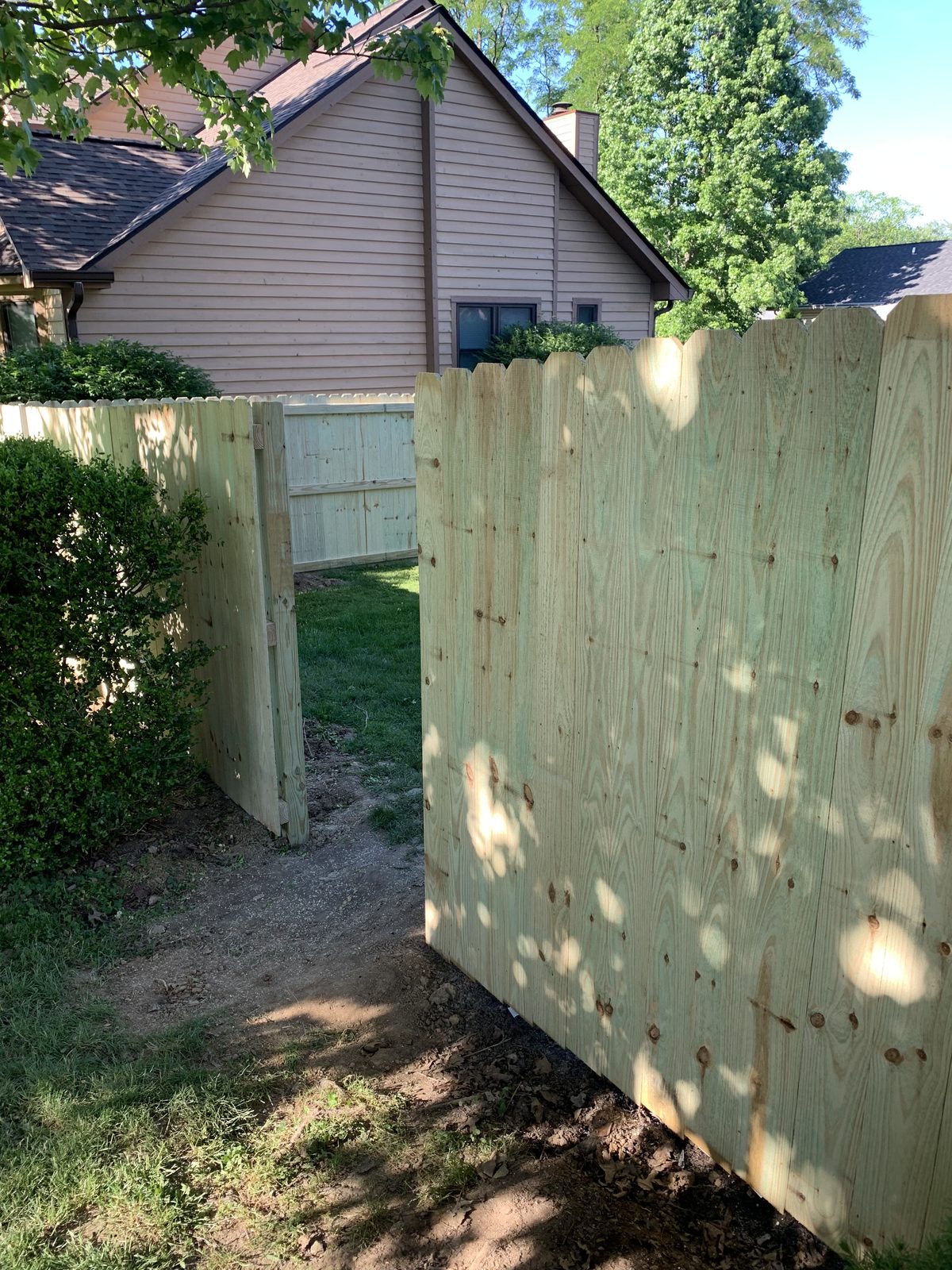 Wood privacy fence with a gate opening in Bloomington, IN