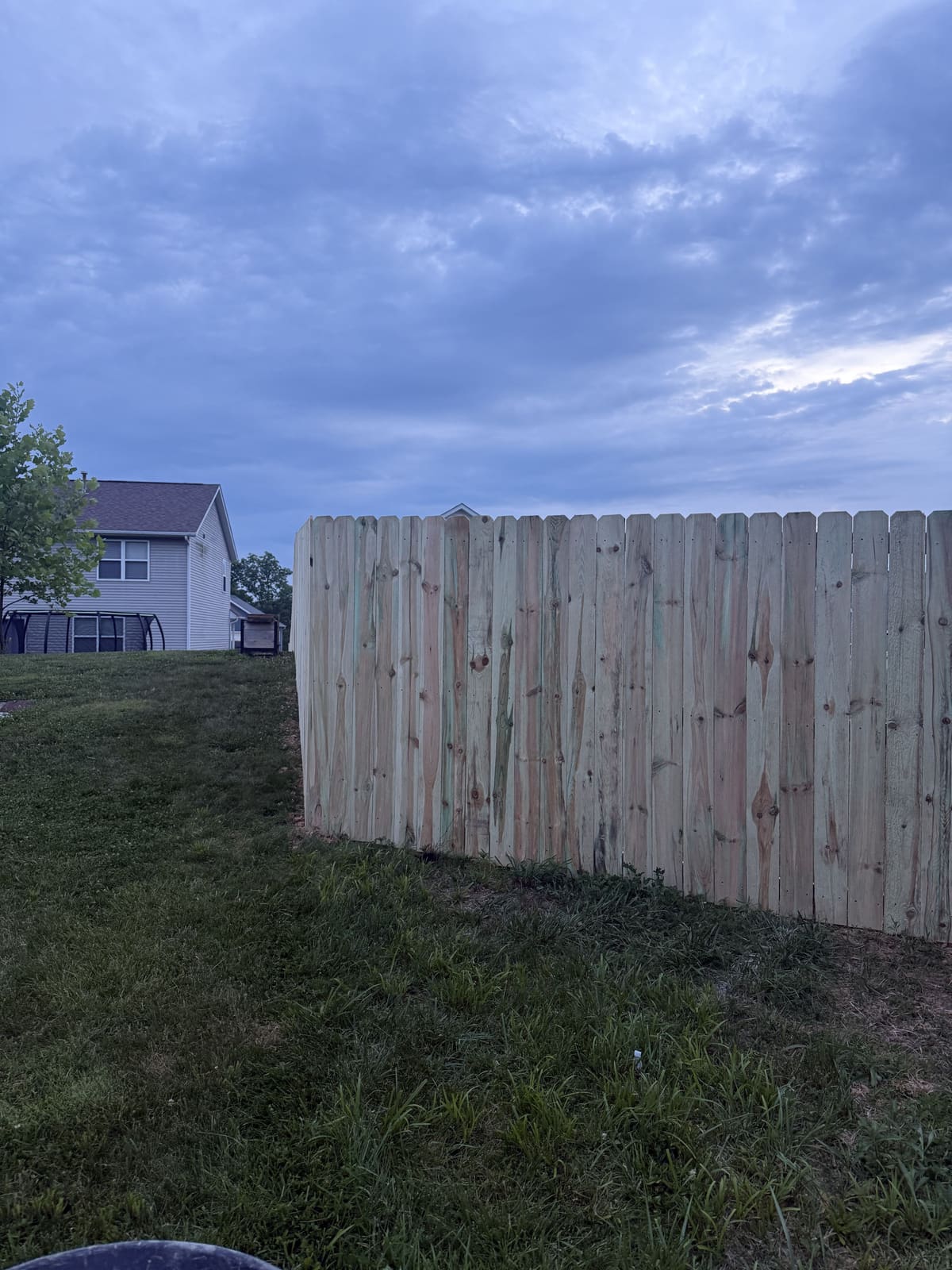 Wood privacy fence built on a hillside in Bloomington, IN
