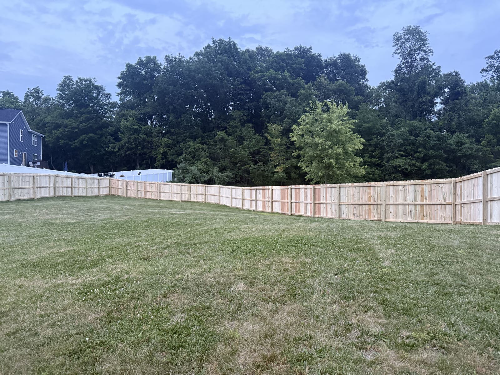 Wood privacy fence enclosing a large backyard in Bloomington, IN